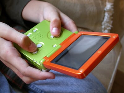 a young boy playing a handheld video game